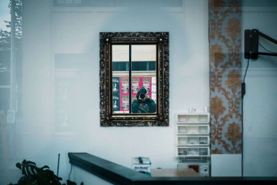 Spiegelwand creëert surrealistisch diepte-effect woonkamer.